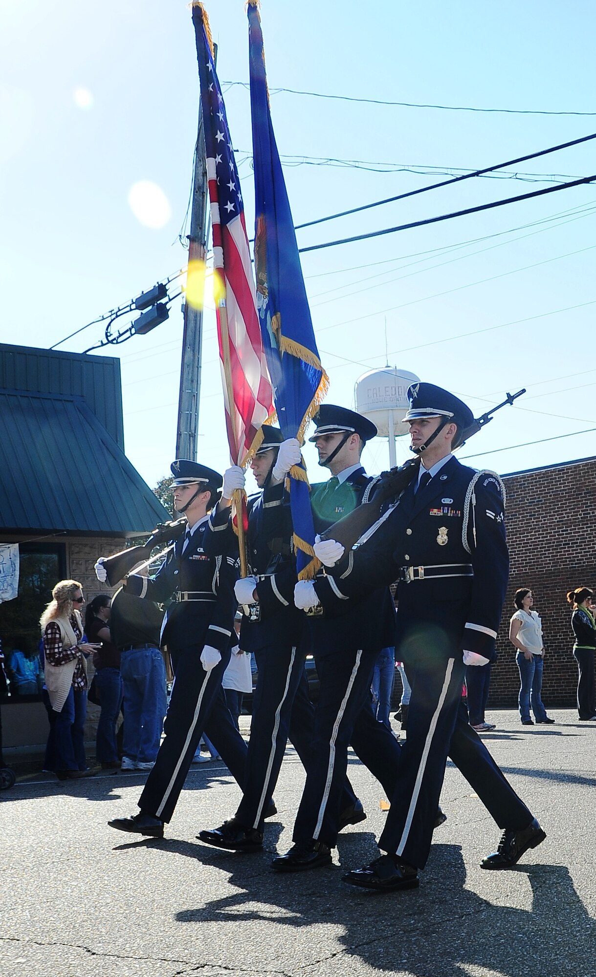 Four Columbus Air Force Base Honor Guardsmen carry the United States flag and the Air Force flag in a parade through the streets of Caledonia Nov. 21. Honor Guard is often involved in community events that show the public the face of the Air Force. (U.S. Air Force photo/Airman John Day) 