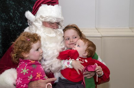 Claire (left), Sam (front) and Kate (rear) Joffrion, children of Justin and Melissa Joffrion, visit with Santa during the annual Christmas tree lighting ceremony Dec. 4 at Joint Base San Antonio-Randolph’s Washington Circle. Santa posed for photos with children inside JBSA-Randolph’s Taj rotunda. (U.S. Air Force photo by Johnny Saldivar)