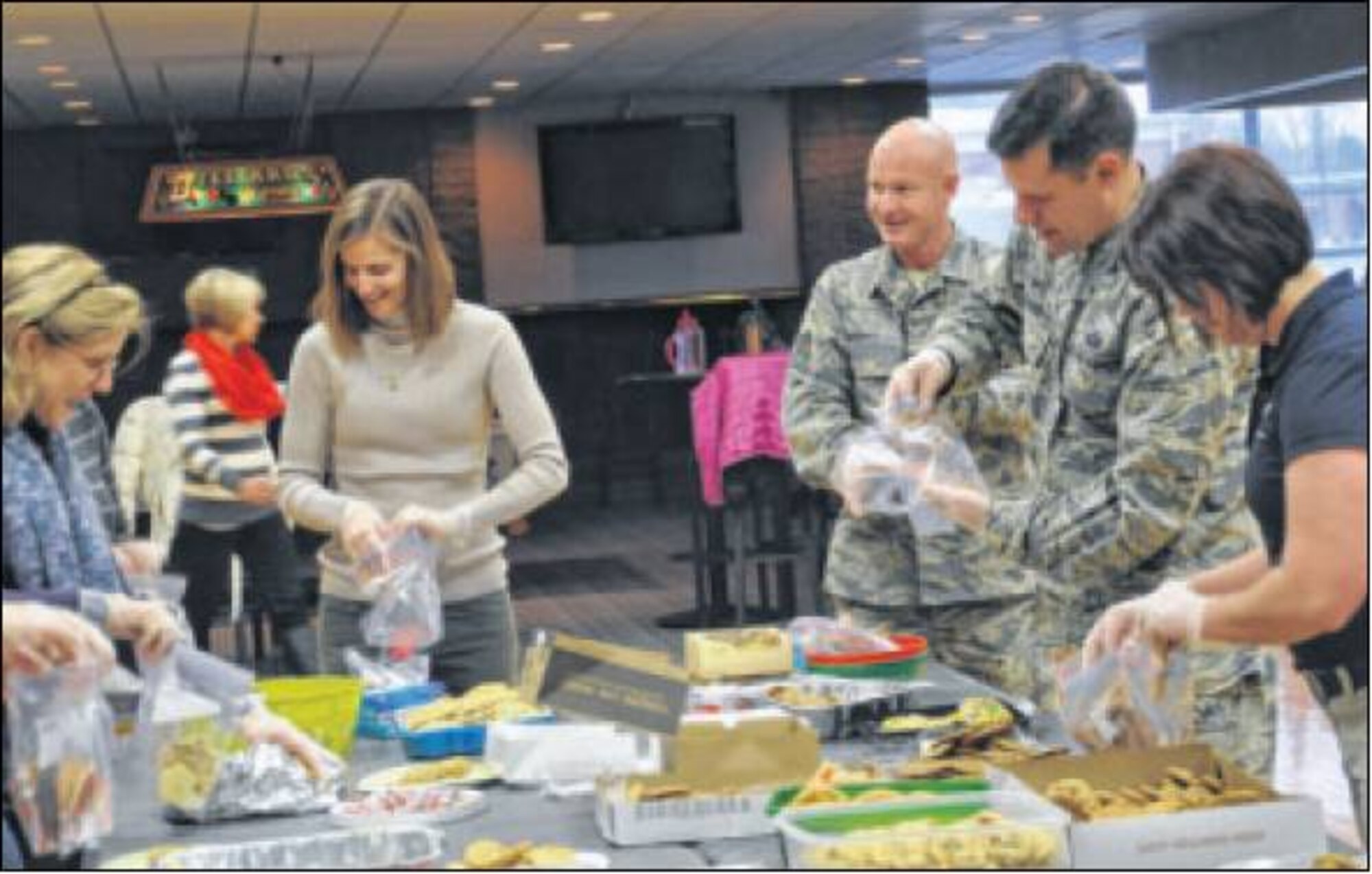 Kathryn Devillier (center) also helped package the cookies. Sponsors of the holiday cookie drive include the enlisted and officers’ spouses clubs and the city of Fairborn.. (Air Force photos by Diane Kofoed)