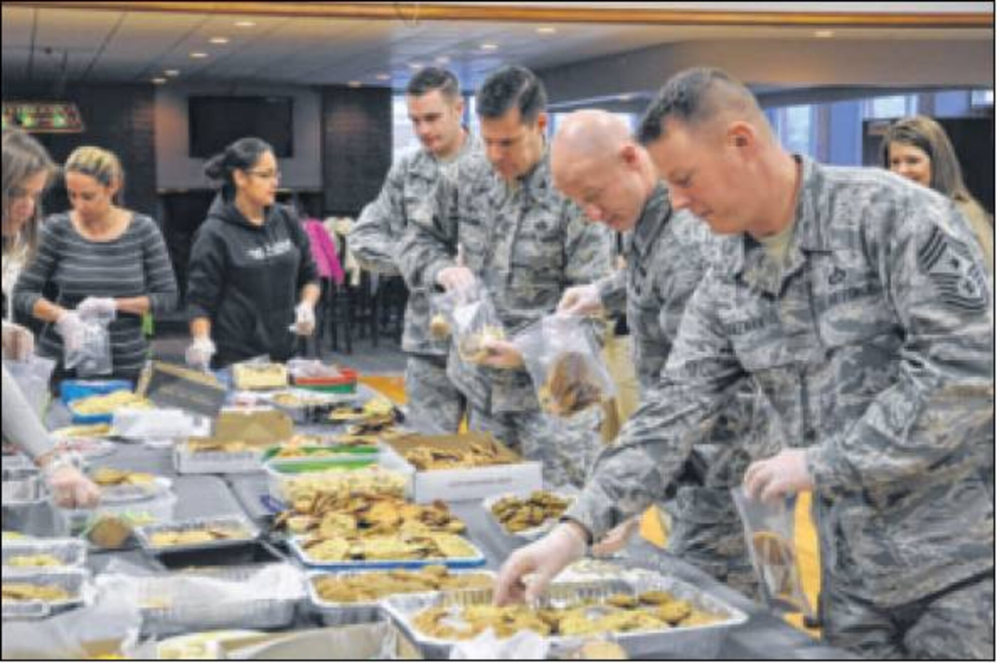 Packaging cookies were volunteers from the 88th Air Base Wing, including (from right) Chief Master Sgt. Charles Hoffman, 88 ABW command chief; Staff Sgt. Austin Carroll; Col. John Devillier, 88 ABW commander; and 2nd Lt. Vincent Berry. (Air Force photos by Diane Kofoed)