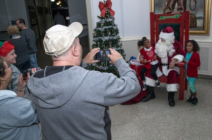 Justice and Lyrie Martin have their photo taken with Santa during the annual Christmas tree lighting ceremony Dec. 4 at Joint Base San Antonio-Randolph’s Washington Circle. Santa posed for photos with children inside JBSA-Randolph’s Taj rotunda. (U.S. Air Force photo by Johnny Saldivar)