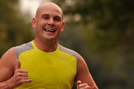 U.S. Navy Lt. Joshua Ludwig, a 626 prototype instructor with the Naval Nuclear Power Plant Training Unit, runs towards the finish line during a 5k run on Joint Base Charleston, S.C., Dec. 4, 2014. The monthly fitness challenge is a 628th Air Base Wing initiative intended to encourage teamwork and camaraderie as part of Comprehensive Airmen Fitness.(U.S. Air Force photo/Staff Sgt. Renae Pittman)