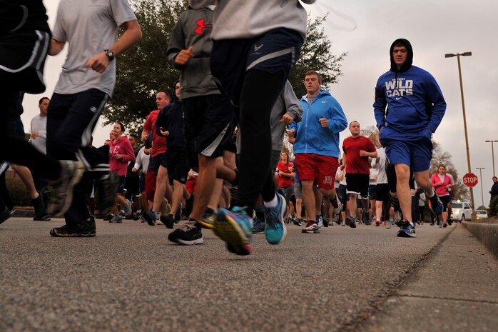 Members of Joint Base Charleston participate in a 5K run as part of the monthly fitness challenge at the Air Base fitness center on Dec. 5, 2014. Each month, the 628th Force Support Squadron hosts different fitness challenges on the first Friday of every month. (U.S. Air Force photo/Staff Sgt. Renae Pittman)