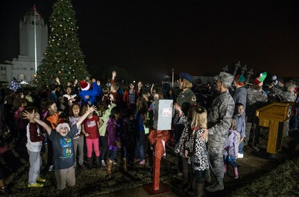 Avery and Ashley Brockoff, Randolph Elementary students, and Brig. Gen. Bob LaBrutta, 502nd Air Base Wing and Joint Base San Antonio commander, flip the switch to light the Christmas tree at the annual lighting ceremony Dec. 4 at JBSA-Randolph’s Washington Circle. The JBSA-Randolph community gathered for carols and photos with Santa. (U.S. Air Force photo by Johnny Saldivar)