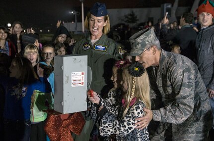 Avery and Ashley Brockoff, Randolph Elementary students, and Brig. Gen. Bob LaBrutta, 502nd Air Base Wing and Joint Base San Antonio commander, along with Col. Jodi Neff, 12th Flying Training Wing vice  commander, flip the switch to light the Christmas tree at the annual lighting ceremony Dec. 4 at JBSA-Randolph’s Washington Circle. The JBSA-Randolph community gathered for carols and photos with Santa. (U.S. Air Force photo by Johnny Saldivar)