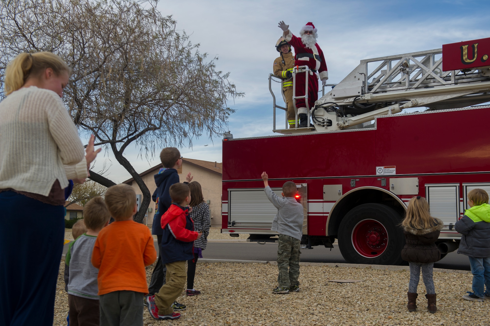 A holiday parade featuring Santa Claus took a trip throughout Soaring Heights housing community at Holloman Air Force Base, N.M., Dec. 2. Team Holloman members teamed up to offer various holiday activities for families to gear up for the holiday season. The event included snacks and drinks, along with a jump house for children to enjoy. Children were given the opportunity to meet Santa at the Base Exchange, and school choirs from Alamogordo Public Schools performed for everyone in attendance. (U.S. Air Force photo by Airman 1st Class Aaron Montoya / Released)