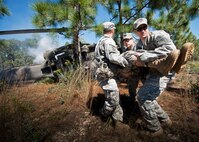 Army first responders move an injured victim away from the simulated helicopter crash during the 6th Ranger Training Battalion’s annual major accident response exercise Oct. 16 at Eglin Air Force Base, Fla. Medics and first responders from the 6th RTB, 96th Test Wing and the local area responded to boating and down aircraft scenarios deep within the Eglin range.