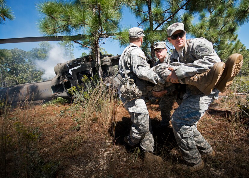 Army first responders move an injured victim away from the simulated helicopter crash during the 6th Ranger Training Battalion’s annual major accident response exercise Oct. 16 at Eglin Air Force Base, Fla. Medics and first responders from the 6th RTB, 96th Test Wing and the local area responded to boating and down aircraft scenarios deep within the Eglin range.