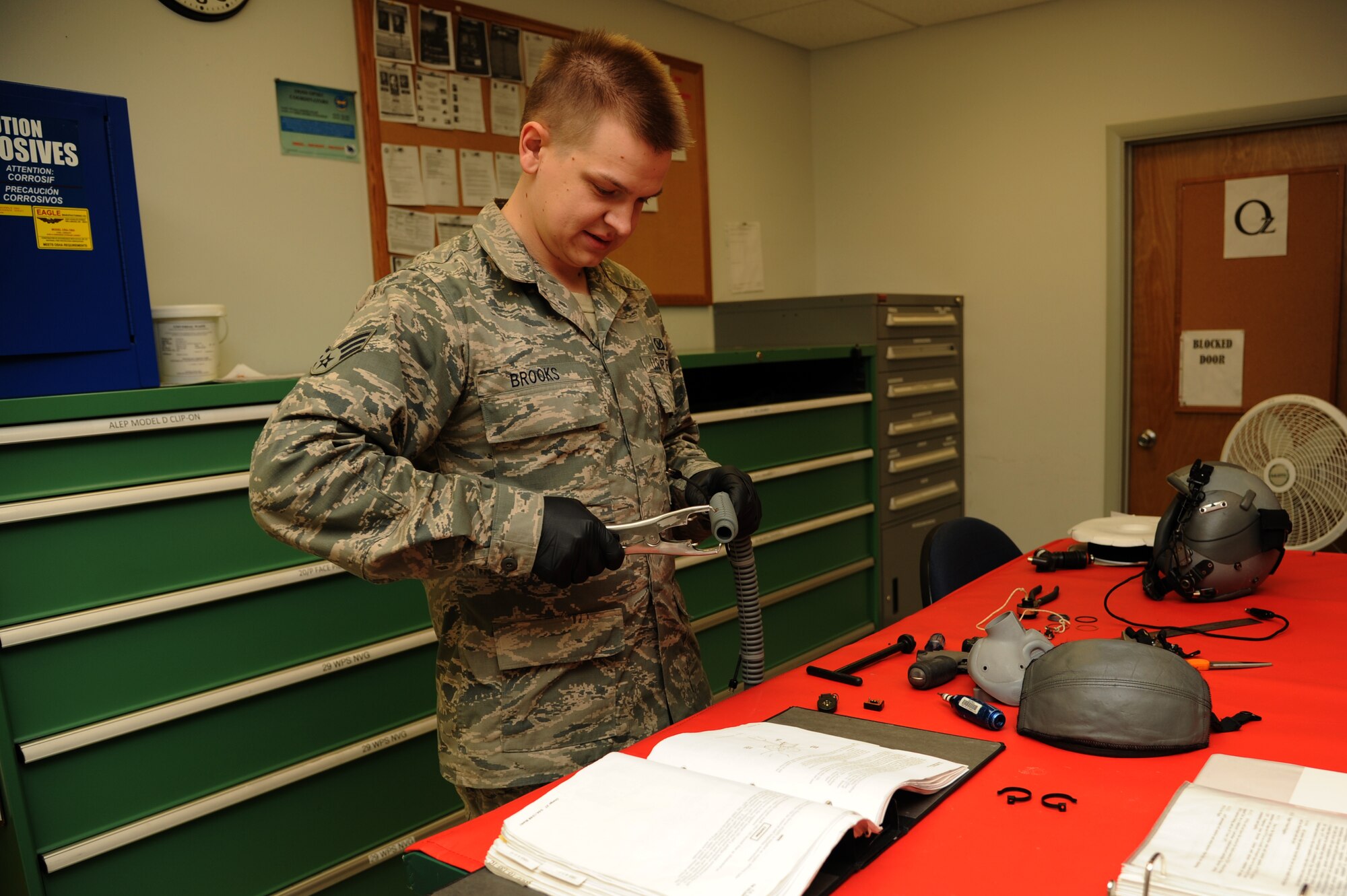 Senior Airman Brandon Brooks, a 19th Operations Support Squadron aircrew flight equipment technician, repairs a hose in an oxygen mask Nov. 25, 2014, at Little Rock Air Force Base, Ark. In the oxygen section of aircrew flight equipment, Airmen are responsible for providing oxygen masks for pilots and their crew. (U.S. Air Force photo by Airman 1st Class Mercedes Muro)