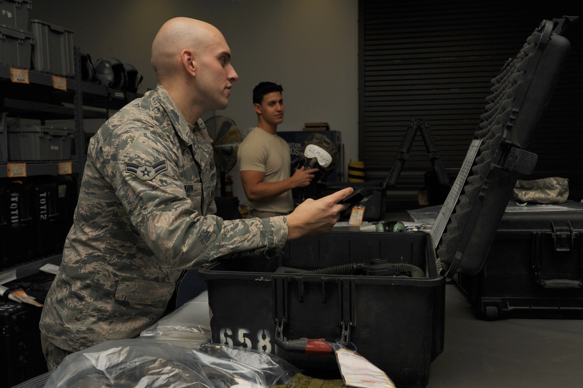 Airman 1st Class Ben Amman, a 19th Operations Force Support Squadron aircrew flight equipment technician, assembles a gas mask Nov. 24, 2014, at Little Rock Air Force Base, Ark. Airmen who work in the chemical defense section of aircrew flight equipment are responsible for issuing equipment that can be utilized in chemical warfare.  (U.S. Air Force photo by Airman 1st Class Mercedes Muro)