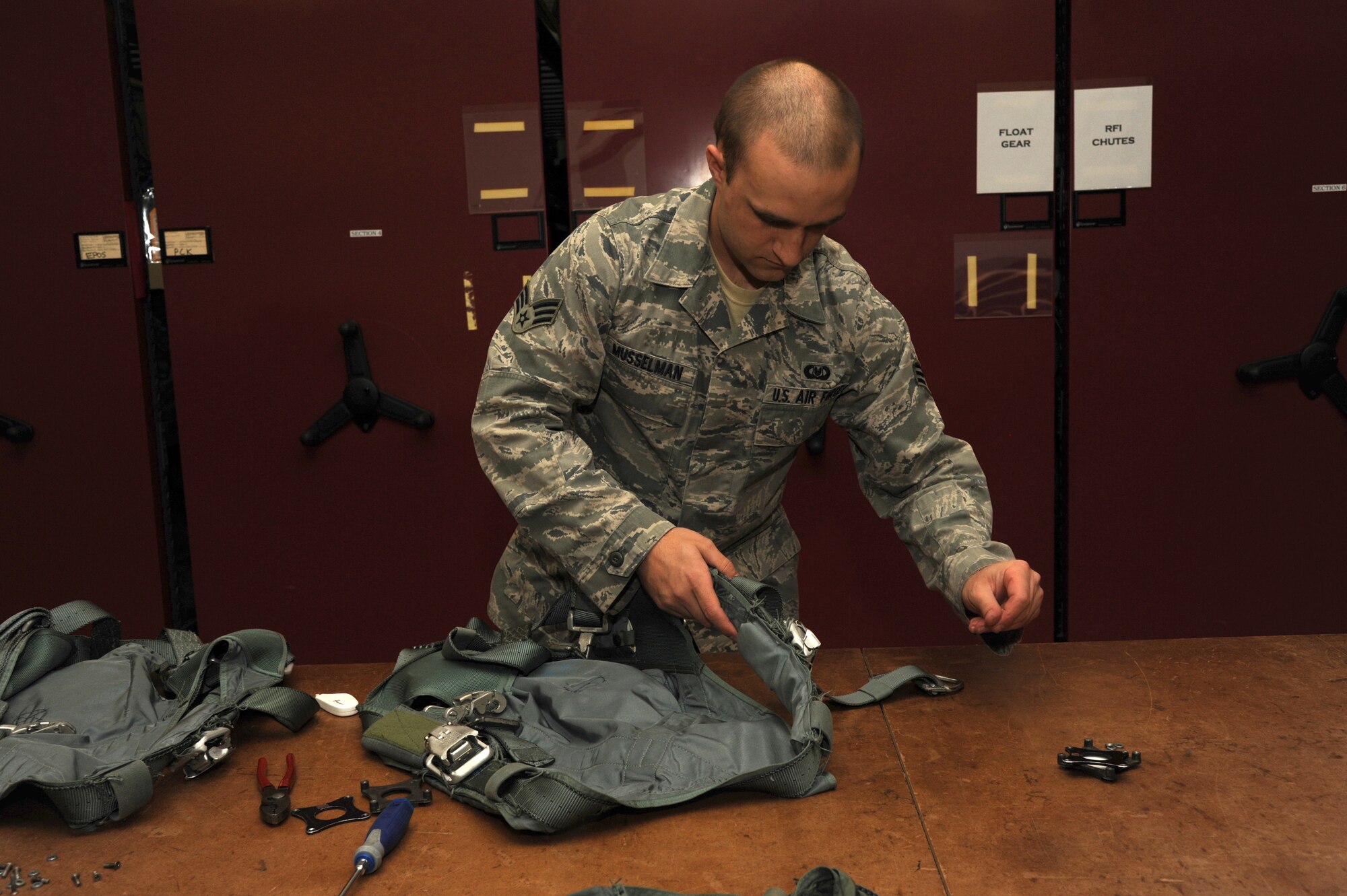 Senior Airman Brad Musselman, a 19th Operations Support Squadron aircrew flight equipment technician, fixes a restraint harness Nov. 24, 2014, at Little Rock Air Force Base, Ark. Restraint harnesses are intended for keeping loadmasters in the aircraft while offloading cargos and jumpers during a flight. (U.S. Air Force photo by Airman 1st Class Mercedes Muro)
