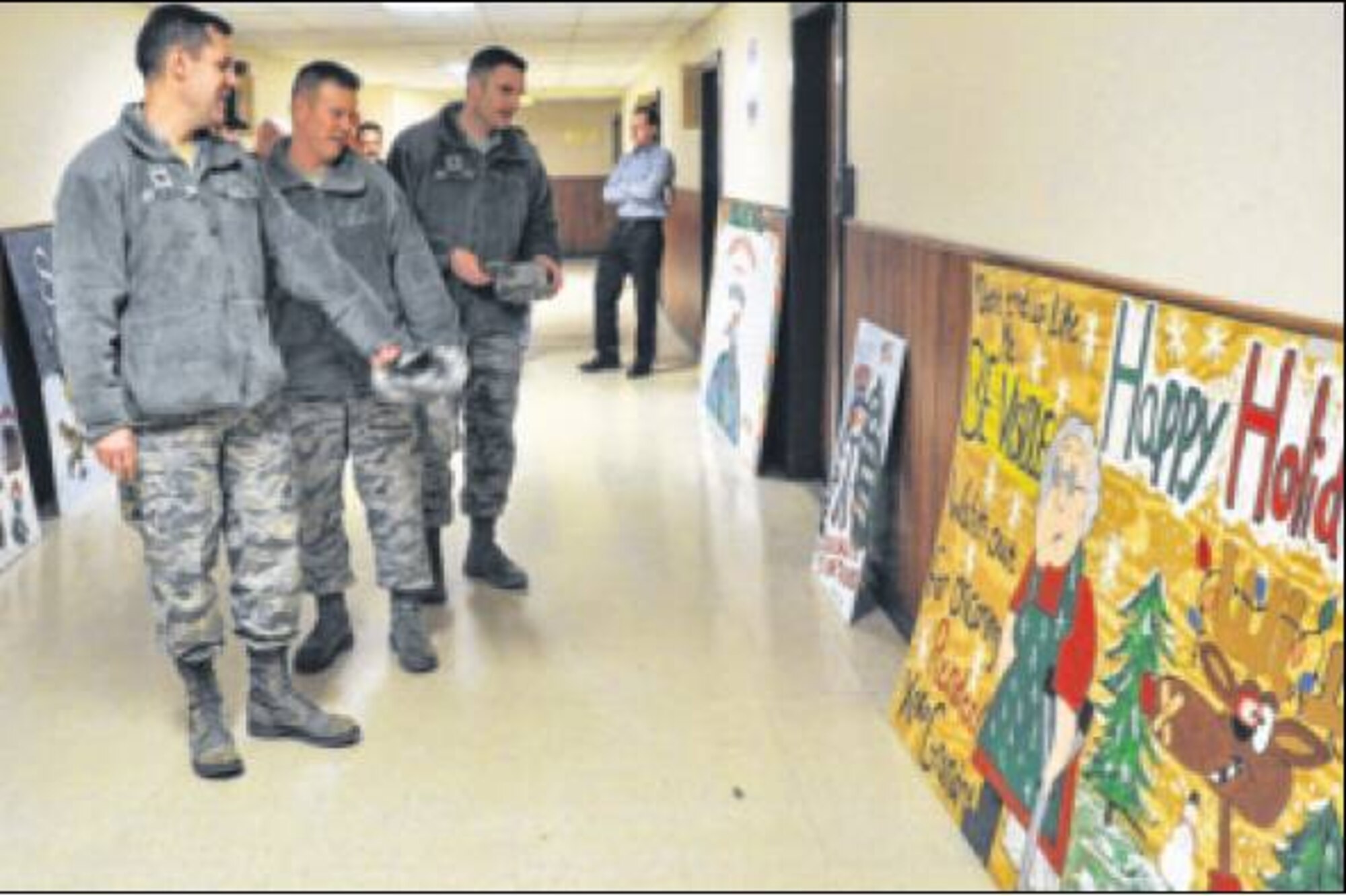 Col. John Devillier, 88th Air Base Wing commander, and Chief Master Sgt. Charles Hoffman, 88 ABW command chief, reviewed the holiday card entries Dec. 3 to select a winner for the competition. Entries were judged based on theme, originality and workmanship. Later that night at the Holiday Tree Lighting ceremony at the Wright-Patt Club, the winner was revealed. (Air Force photos by Diane Kofoed) 