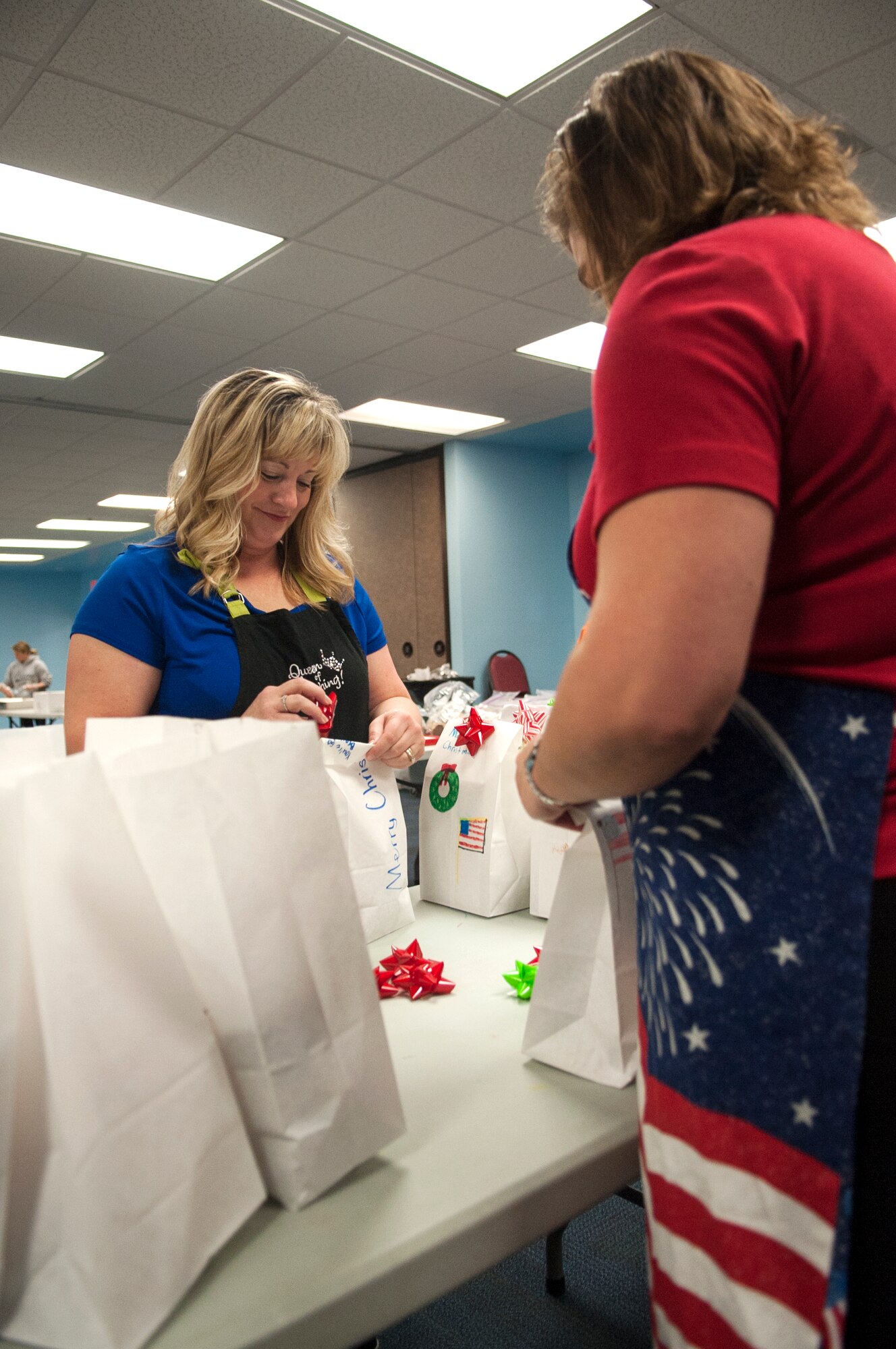 Volunteers decorate packages for dorm residents during the Airmen Cookie Drive Dec. 4, 2014, at Moody Air Force Base, Ga. First sergeants distributed the baked goods to Airmen living in the dorms. (U.S. Air Force photo by Senior Airman Marrero/Released)

