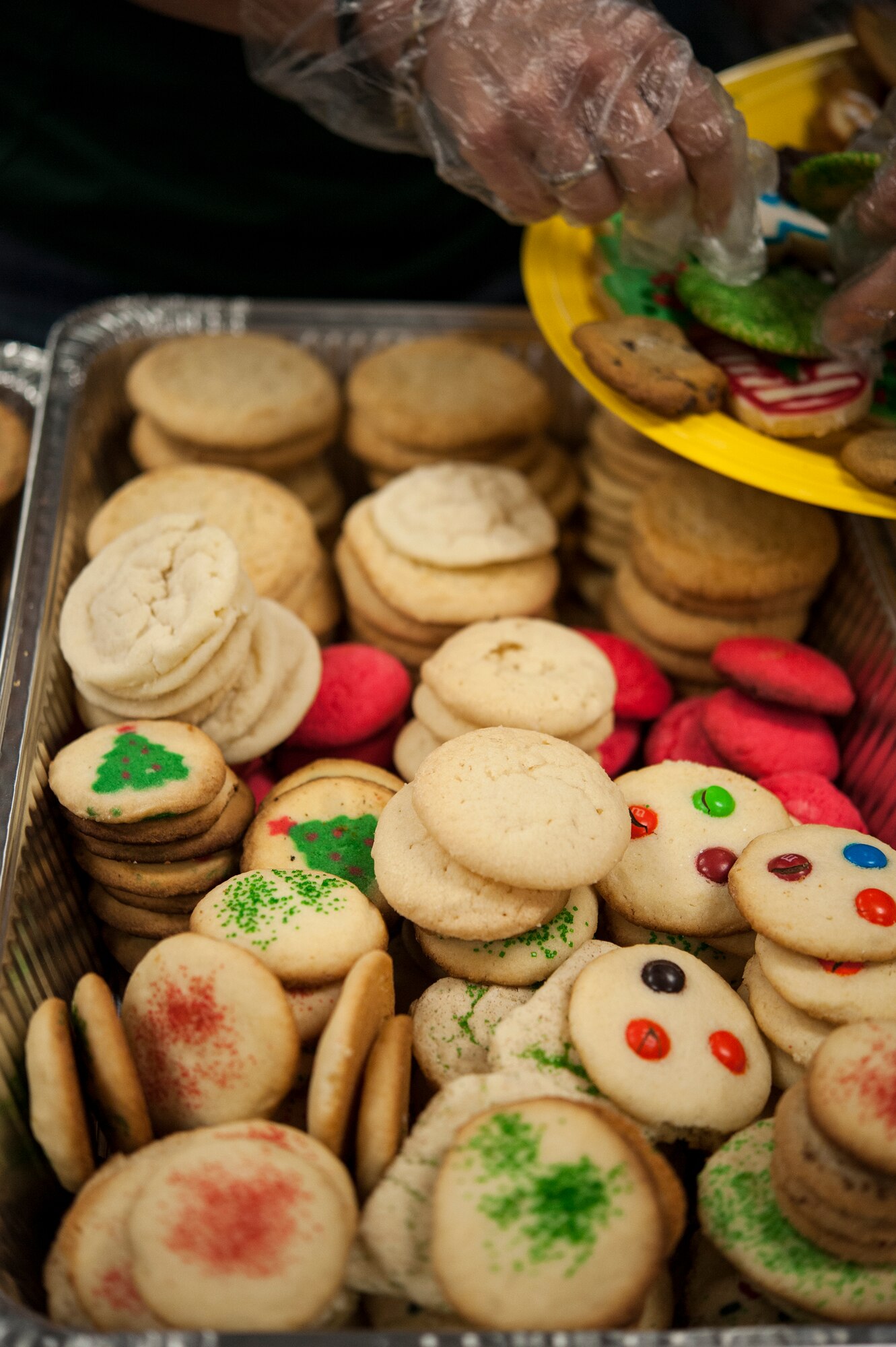 A volunteer sorts through cookies during the Airmen Cookie Drive Dec. 3, 2014, at Moody Air Force Base, Ga. The cookie drive aims to boost the morale of dorm residents by providing them baked goods during the holidays. (U.S. Air Force photo by Senior Airman Marrero/Released)
