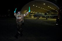 Staff Sgt. Robert Dupree, 25th Aircraft Maintenance Unit dedicated crew chief, marshals an A10 Thunderbolt II pilot Dec. 5, 2014, during Exercise Beverly Bulldog 15-01 at Osan Air Base, Republic of Korea. The exercise focuses on readiness, testing Osan’s wartime procedures, and realistically looking at our ability to defend the base, execute operations and receive follow-on forces. (U.S. Air Force photo by Senior Airman David Owsianka)