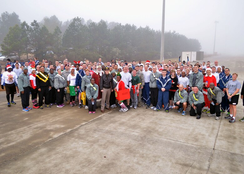 Fort Bragg Airmen and Soldiers participate in the Air Force’s annual Operation Toy Trot 5K race here Dec. 3, collecting toys for the annual Randy Oler Memorial Operation Toy Drop scheduled for Dec. 5 thru Dec. 7. Over 150 servicemembers dressed in holiday and fitness attire, donated toys and competed in the 5K race around the Pope Field flight line to help kickoff this year’s U.S. Army Civil Affairs and Psychological Operations Command’s (Airborne) annual Operation Toy Drop. Over its 17-year span, Operation Toy Drop has collected and distributed thousands of toys for children in the Sandhills, North Carolina area. (U.S. Air Force photo/Marvin Krause)