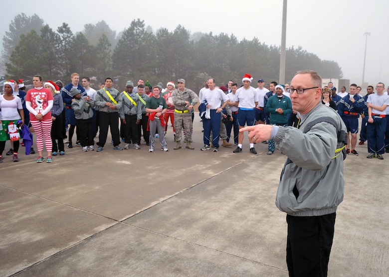 Col. Michael Harvey, Operation Toy Drop ground operations officer in charge assigned to U.S. Army Civil Affairs and Psychological Operations Command (Airborne), thanks Fort Bragg Airmen and Soldiers who participated in the Air Force’s annual Operation Toy Trot 5K race here Dec. 3. The event raised toys for the annual Randy Oler Memorial Operation Toy Drop scheduled for Dec. 5 thru Dec. 7. Over 150 servicemembers dressed in holiday and fitness attire, donated toys and competed in the 5K race around the Pope Field flight line to help kickoff this year’s U.S. Army Civil Affairs and Psychological Operations Command’s (Airborne) annual Operation Toy Drop. Over its 17-year span, Operation Toy Drop has collected and distributed thousands of toys for children in the Sandhills, North Carolina area. (U.S. Air Force photo/Marvin Krause)