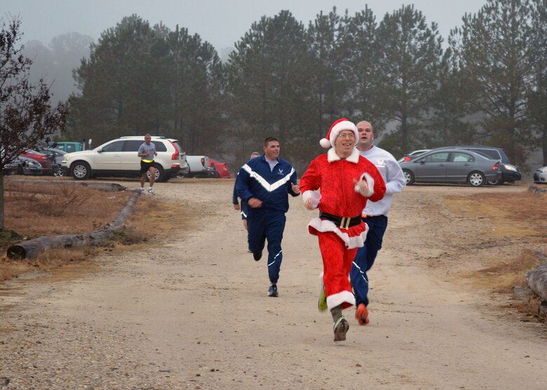 Fort Bragg Airmen and Soldiers participate in the Air Force’s annual Operation Toy Trot 5K race here Dec. 3, collecting toys for the annual Randy Oler Memorial Operation Toy Drop scheduled for Dec. 5 thru Dec. 7. Over 150 servicemembers dressed in holiday and fitness attire, donated toys and competed in the 5K race around the Pope Field flight line to help kickoff this year’s U.S. Army Civil Affairs and Psychological Operations Command’s (Airborne) annual Operation Toy Drop. Over its 17-year span, Operation Toy Drop has collected and distributed thousands of toys for children in the Sandhills, North Carolina area. (U.S. Air Force photo/Marvin Krause)