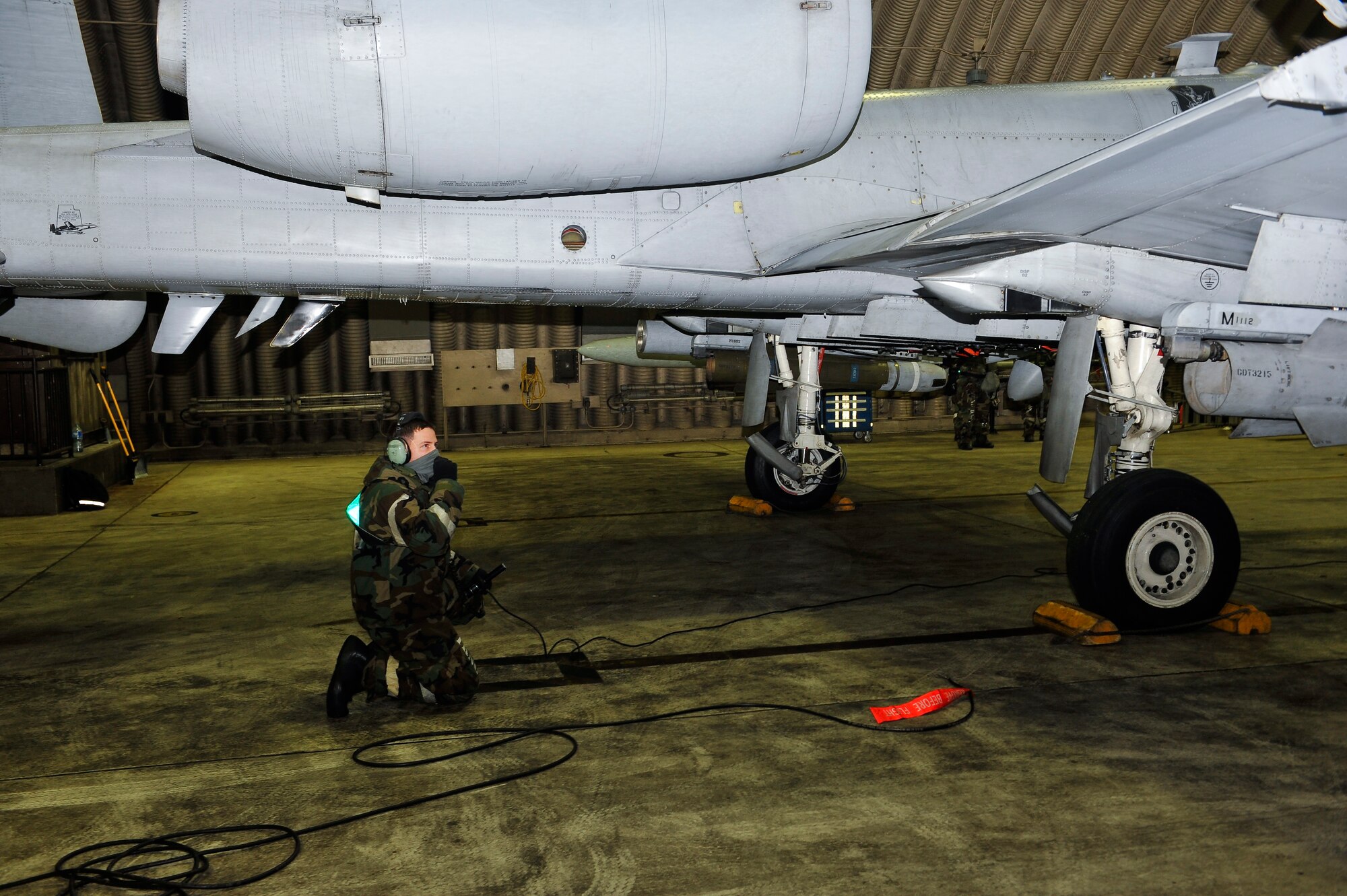 Senior Airman Brian Morrissey, 25th Aircraft Maintenance Unit dedicated crew chief, performs a pre-flight inspection of an A10 Thunderbolt II Dec. 5, 2014, during Exercise Beverly Bulldog 15-01 at Osan Air Base, Republic of Korea. The exercise focuses on readiness, testing Osan’s wartime procedures, and realistically looking at our ability to defend the base, execute operations and receive follow-on forces. (U.S. Air Force photo by Senior Airman David Owsianka)
