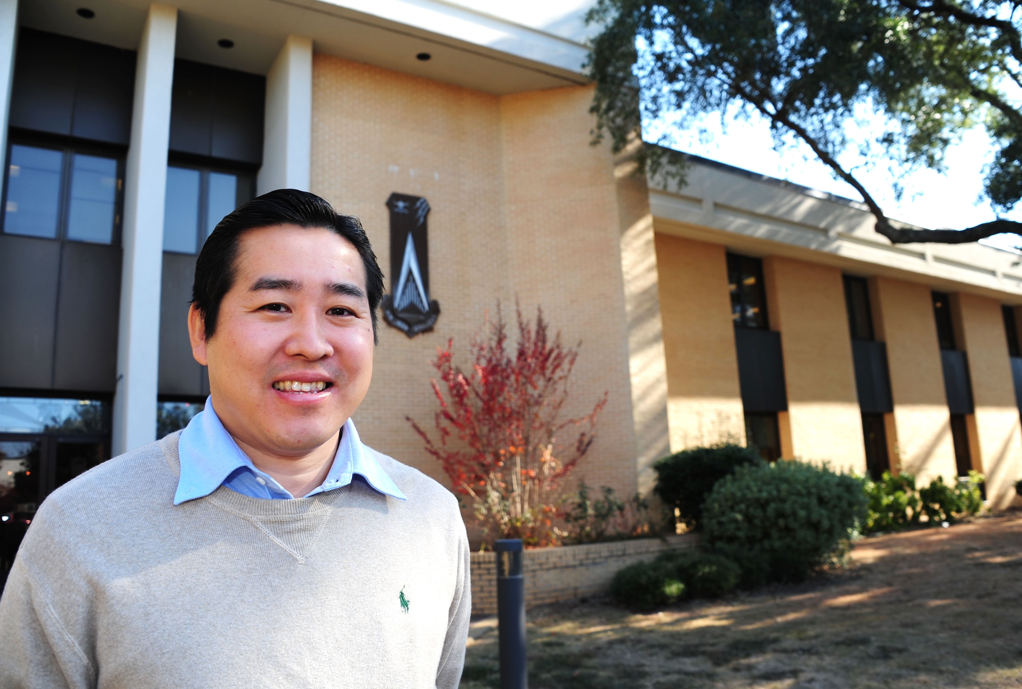 Nori Katagiri, Air War College international security studies assistant professor, stands in front of The Air University’s AWC at Maxwell Air Force Base, Alabama, Nov. 14, 2014. Katagiri was born in Japan before traveling to the U.S. on a student visa and earning his Ph. D. from the University of Pennsylvania. (U.S. Air Force photo by Airman 1st Class Alexa Culbert/Cleared)
