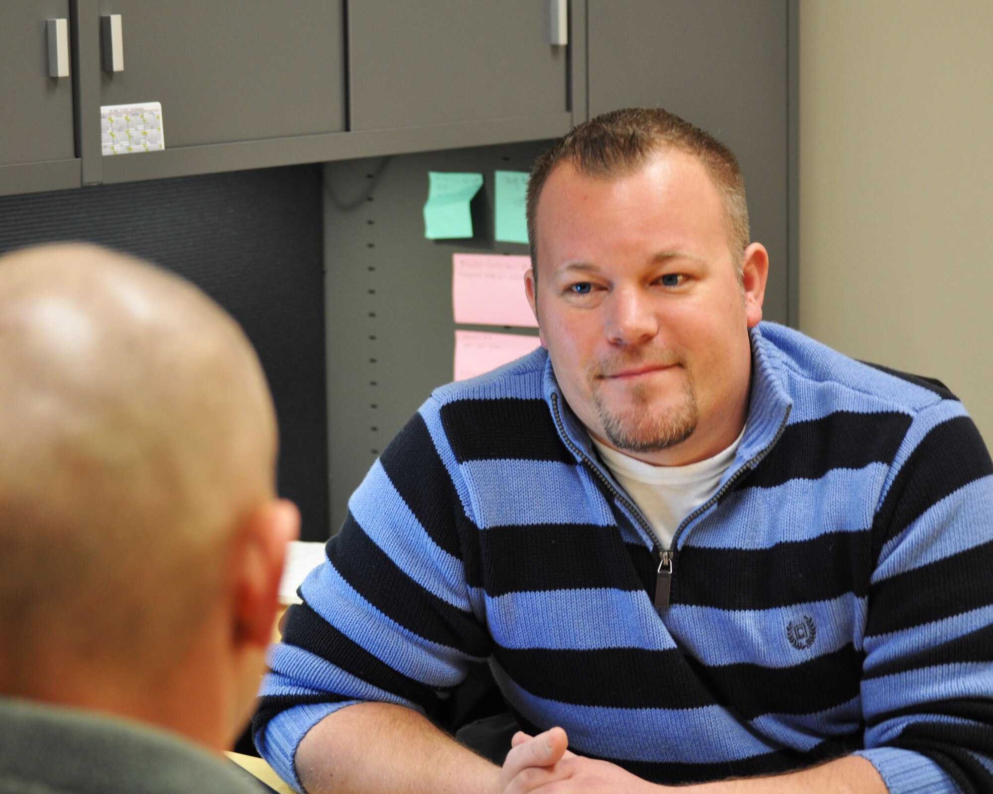 Jeremiah Raymo speaks with a member of the 931st Air Refueling Group, McConnell Air Force Base, Kan., Dec. 5, 2014. Raymo was recently appointed to the 931st ARG as a director of Psychological Health (DPH).  This position enables him to help Reservists cope with stress and other mental health-related concerns. (U.S. Air Force photo by Staff Sgt. Abigail Klein)