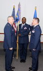 Lt. Col. Jeffrey Snyder salutes Col. Jonathan M. Philebaum, 512th Operations Group commander, during the change of command ceremony for the 512th Operations Support Squadron Nov. 2, 2014, on Dover Air Force Base, Del. Snyder, the new 512th OSS commander, was previously assigned as the 326th Airlift Squadron chief pilot. (U.S. Air Force photo/Herb E. Welday III)