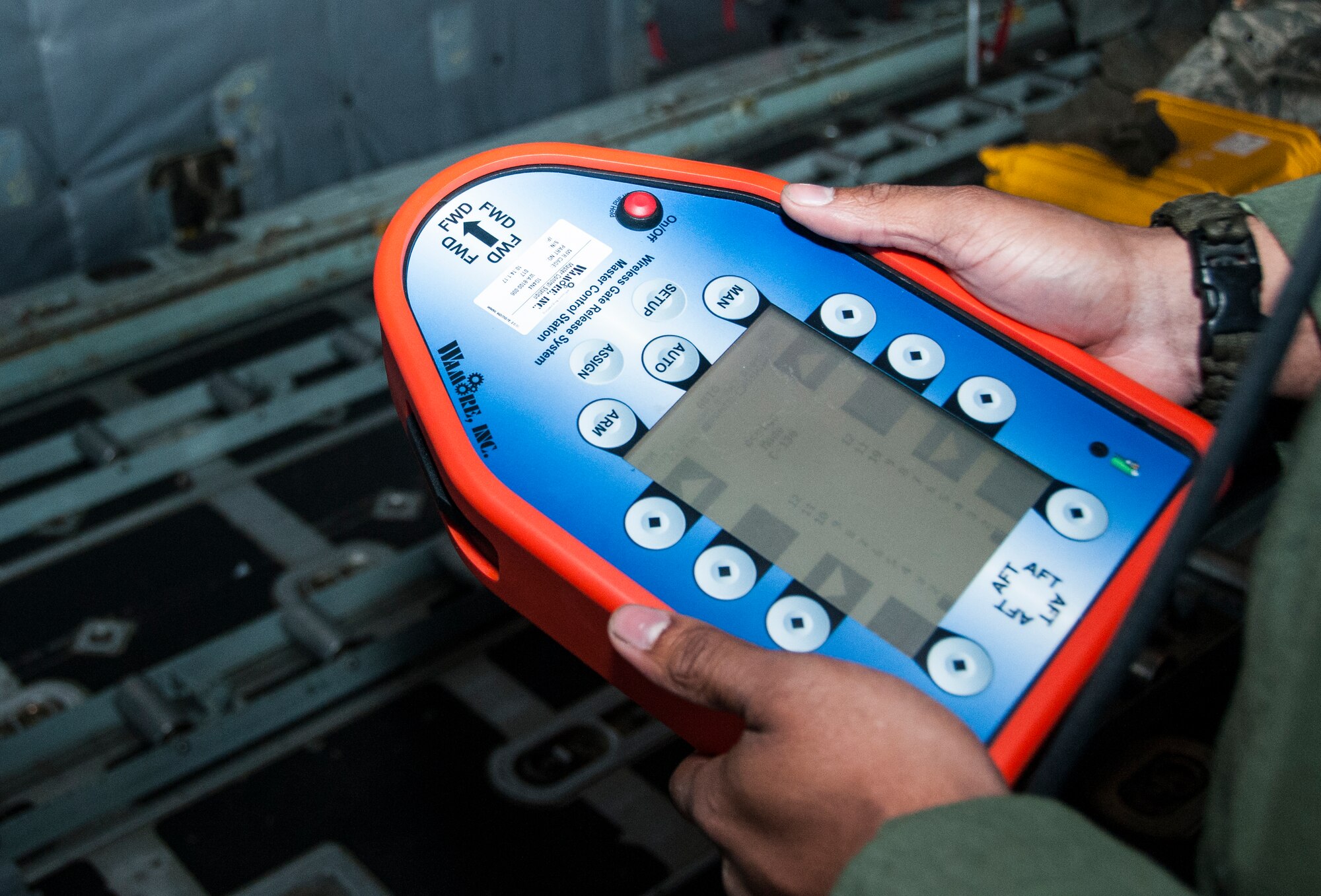 Senior Airman Wes Brown, 700th Airlift Squadron loadmaster, inspects the remote for the wireless gate cutter system at Dobbins Air Reserve Base, Ga. Nov. 20, 2014. The 700th Airlift Squadron maintains combat ready aircrews and aircraft capable of deploying in response to worldwide contingencies and emergencies. (U.S. Air Force photo by Senior Airman Daniel Phelps/ Released)
