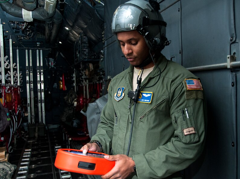 Senior Airman Wes Brown, 700th Airlift Squadron loadmaster, inspects the remote for the wireless gate cutter system at Dobbins Air Reserve Base, Ga. Nov. 20, 2014. The 700th Airlift Squadron maintains combat ready aircrews and aircraft capable of deploying in response to worldwide contingencies and emergencies. (U.S. Air Force photo by Senior Airman Daniel Phelps/ Released)