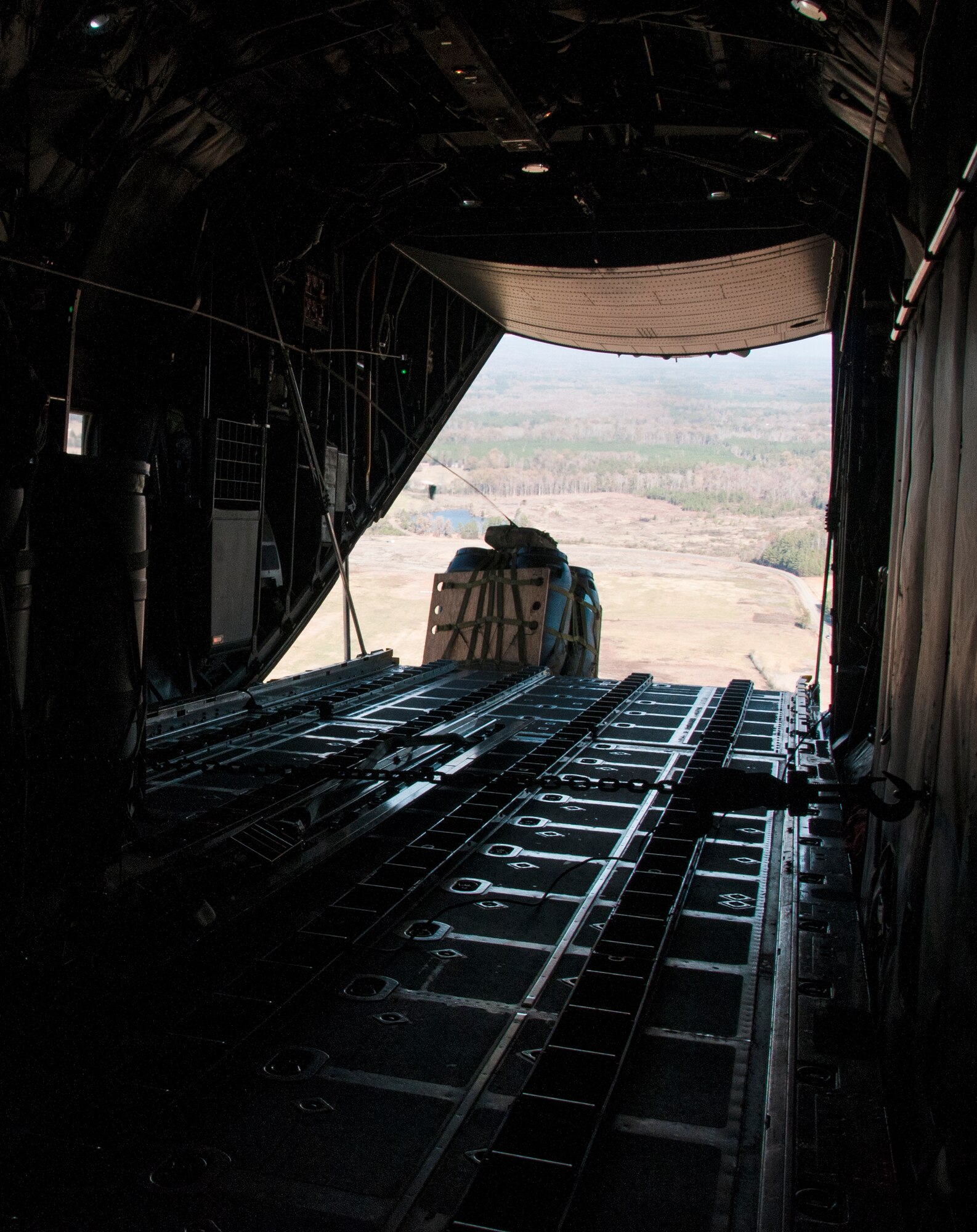 Cargo flies out the back of a U.S. Air Force C-130 Hercules over North Georgia Nov. 20, 2014. In an aerial delivery role, the Hercules can airdrop loads up to 42,000 pounds or use its high-flotation landing gear to land and deliver cargo on rough, dirt strips. (U.S. Air Force photo by Senior Airman Daniel Phelps/Released)