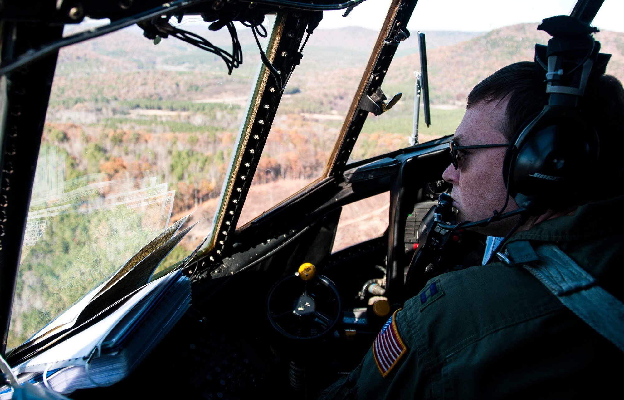 Capt. Patrick Croasdale, C-130 Hercules pilot at Dobbins Air Reserve Base, Ga., scans the landscape for navigational points during a training exercise Nov. 20, 2014. The training exercise was conducted to learn the effectiveness of a new wireless gate release system for tactical air drops. (U.S. Air Force photo by Senior Airman Daniel Phelps)