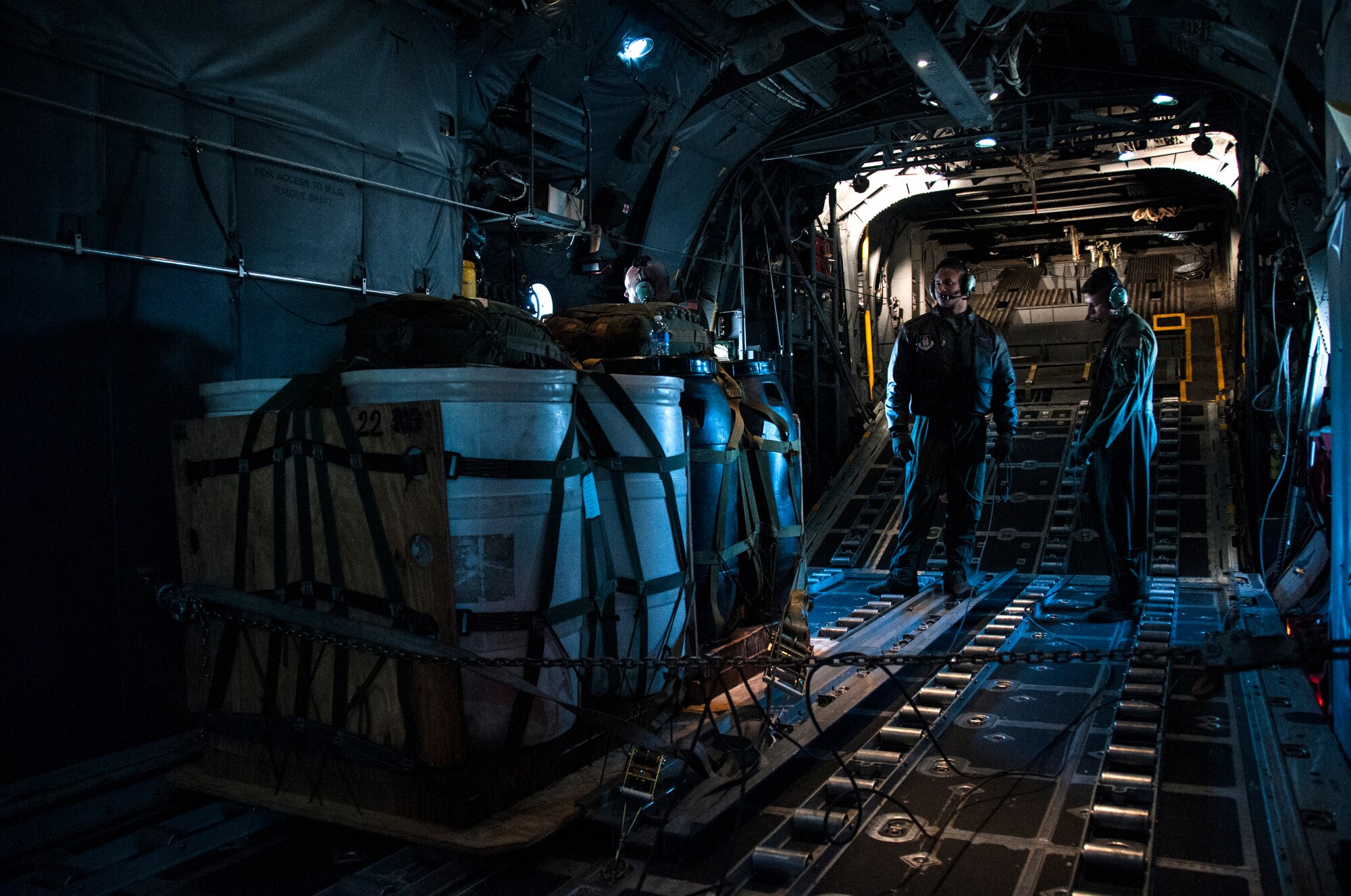 Senior Airman Wes Brown and Tech. Sgt. Mark Hanson, 700th Airlift Squadron loadmasters, inspect cargo for an air drop over Georgia Nov. 20, 2014. Loadmasters accomplish loading and off-loading aircraft functions; and perform pre-flight and post-flight of aircraft and aircraft systems. (U.S. Air Force photo by Senior Airman Daniel Phelps/Released)