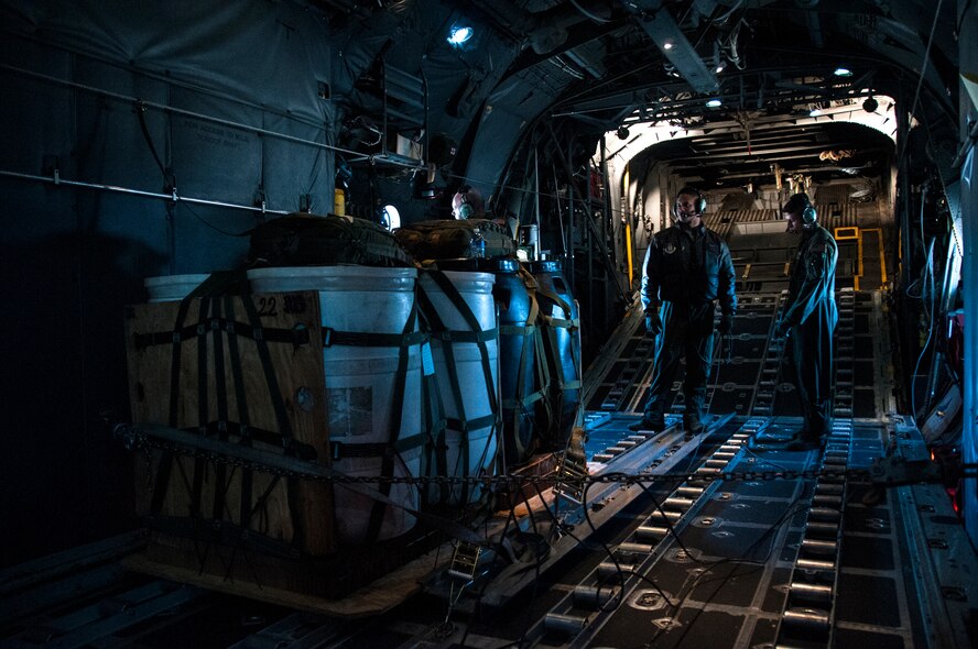 Senior Airman Wes Brown and Tech. Sgt. Mark Hanson, 700th Airlift Squadron loadmasters, inspect cargo for an air drop over Georgia Nov. 20, 2014. Loadmasters accomplish loading and off-loading aircraft functions; and perform pre-flight and post-flight of aircraft and aircraft systems. (U.S. Air Force photo by Senior Airman Daniel Phelps/Released)