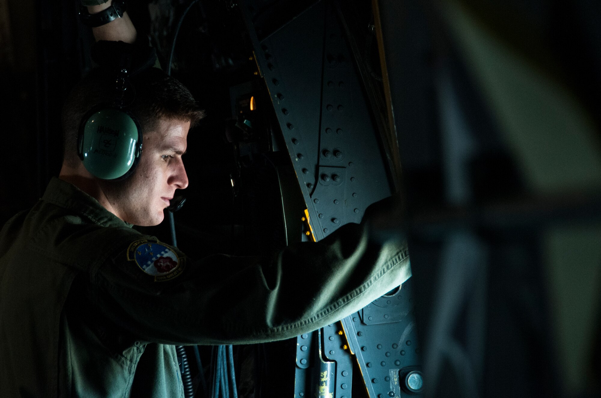 Tech. Sgt. Mark Hanson, 700th Airlift Squadron loadmaster, looks out the window of a U.S. Air Force C-130 Hercules during a training mission over Georgia Nov. 20, 2014. The 700th Airlift Squadron maintains combat ready aircrews and aircraft capable of deploying in response to worldwide contingencies and emergencies. (U.S. Air Force photo by Senior Airman Daniel Phelps/Released)