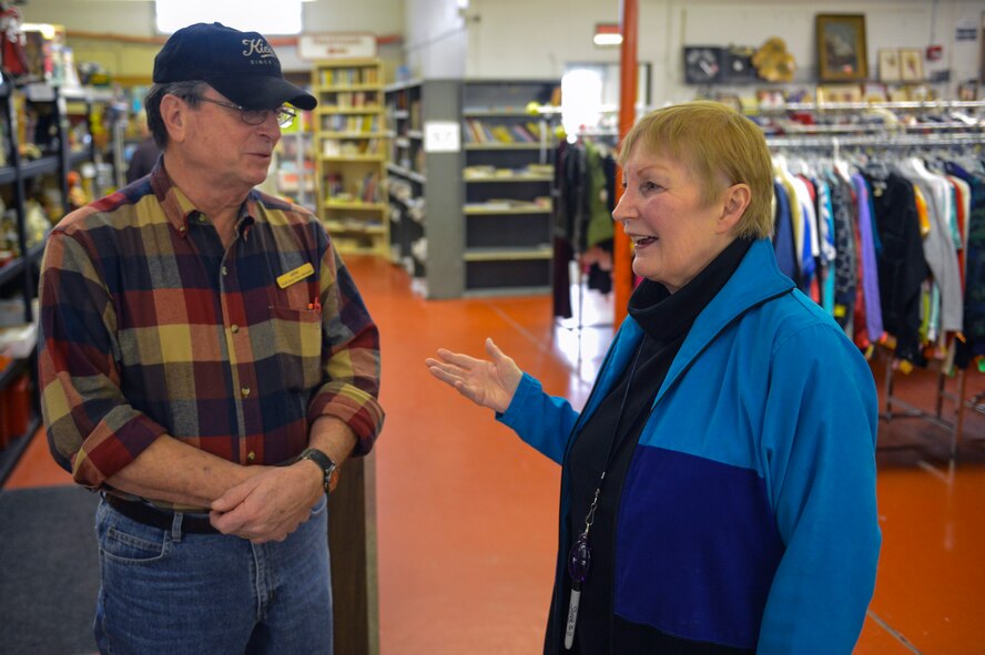 Joan Wasserstrom, McChord Thrift Shop volunteer, and John Able, McChord Thrift Shop manager, discuss the responsibilities that accompany managing the shop Dec. 5, 2014 at Joint Base Lewis-McChord, Wash. The McChord Spouse’s Club offers the Joan Wasserstrom Scholarship every year from money gathered from charity events and proceeds from the McChord Thrift Shop. (U.S. Air Force photo/Staff Sgt. Russ Jackson)