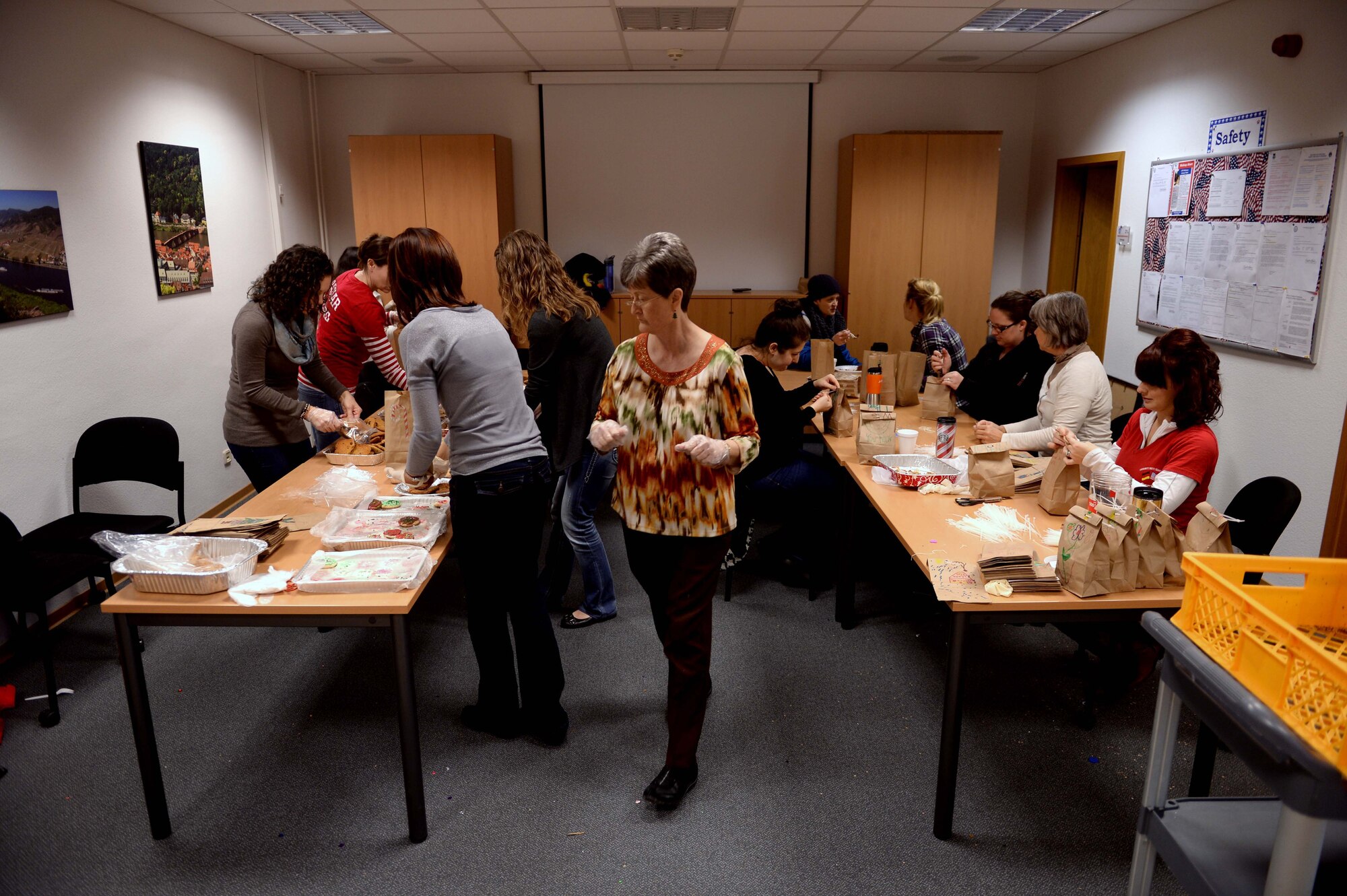 Volunteers work to put together cookie bags at the Airman & Family Readiness Center at Spangdahlem Air Base, Germany, Dec. 4, 2014. The event organizers included purchased movie vouchers from the Army and Air Force Exchange Services in the cookie bags for the Airmen residing in the dorms. (U.S. Air Force photo by Airman 1st Class Timothy Kim/Released)
