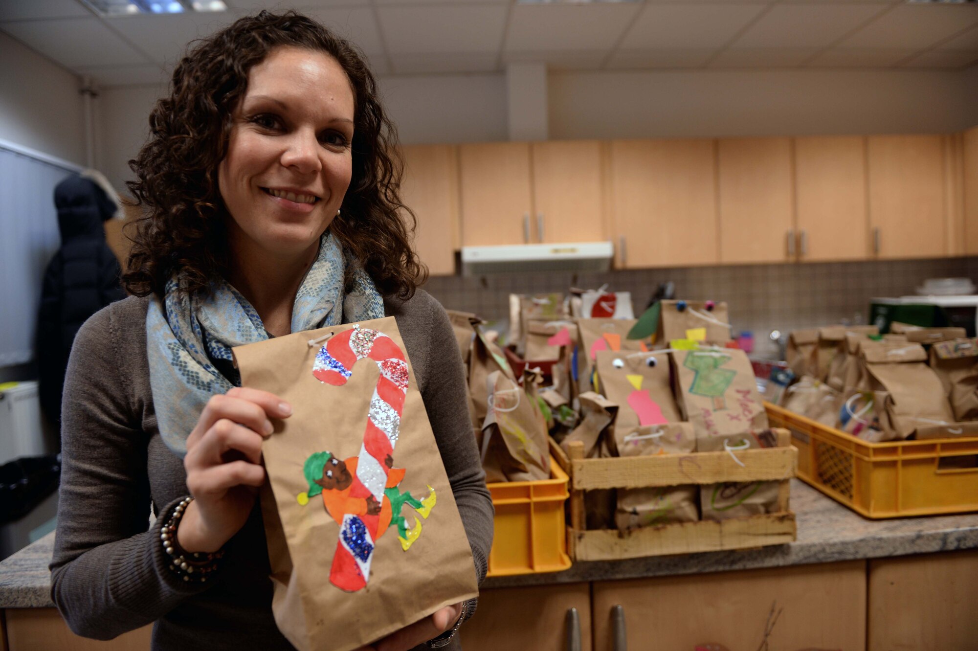 Kim Nudi, the Officers’ and Civilians’ Spouses Club special activities chair and native of Fairfax, Va., holds a bag of cookies at the Airman & Family Readiness Center at Spangdahlem Air Base, Germany, Dec. 4, 2014. The OCSC and Spangdahlem Spouses and Enlisted Members Club collaborated to create a cookie drive to package and deliver donated cookies to Airmen in the dormitories. (U.S. Air Force photo by Airman 1st Class Timothy Kim/Released)