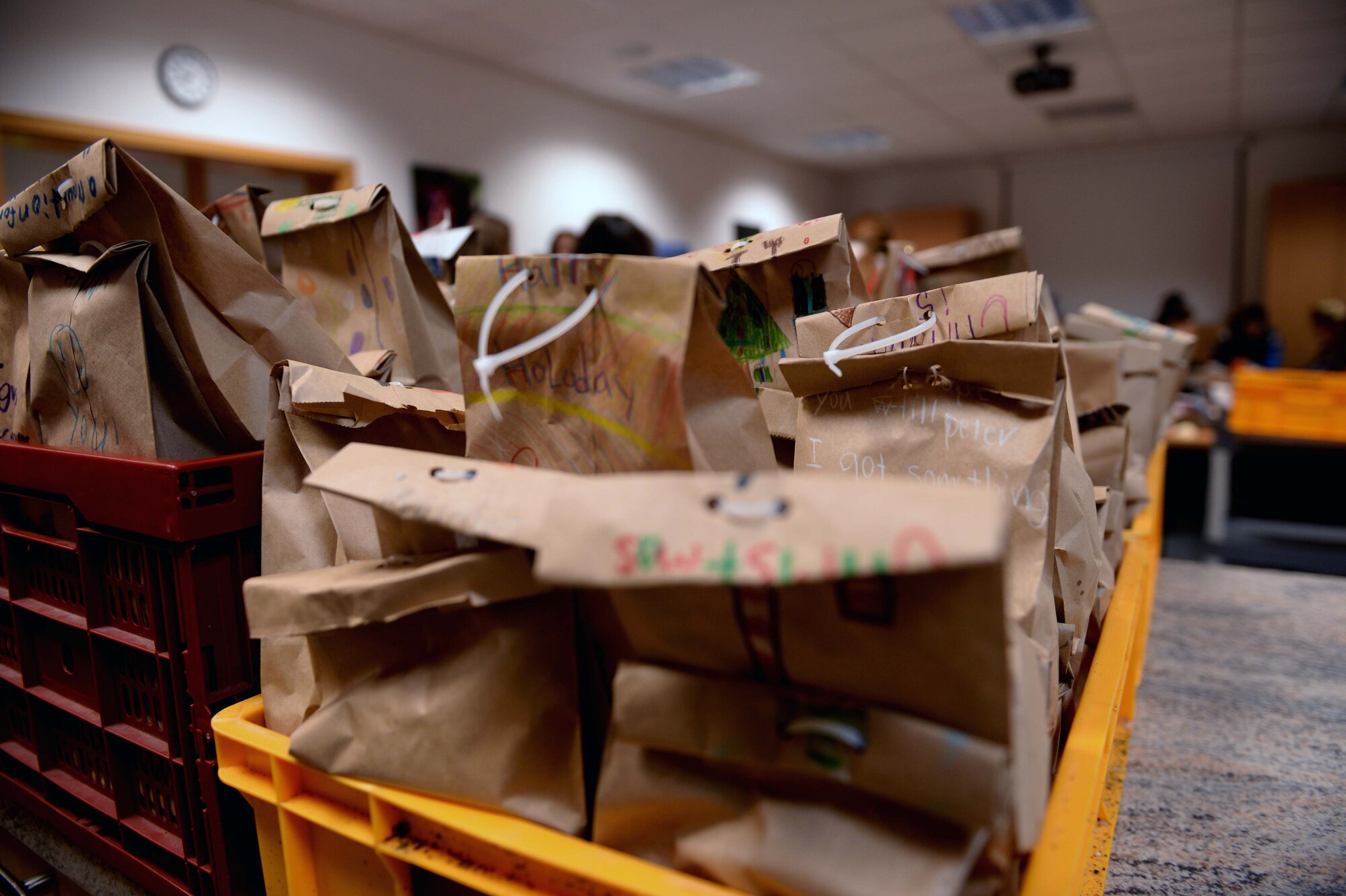 Bags of cookies lay packed in bins at the Airman & Family Readiness Center at Spangdahlem Air Base, Germany, Dec. 4, 2014. First sergeants of different squadrons deliver the donated the bags of cookies to their respective Airmen’s dormitories. (U.S. Air Force photo by Airman 1st Class Timothy Kim/Released)
