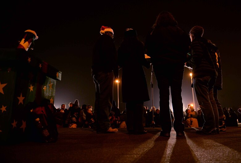 Members of the Singing Sabers perform on stage during the annual tree-lighting ceremony at the Eifel Lanes Bowling Center on Spangdahlem Air Base, Germany, Dec. 4, 2014. The singers performed holiday songs, including “We wish you a Merry Christmas” and “Jingle Bells.” (U.S. Air Force photo by Airman 1st Class Timothy Kim/Released)