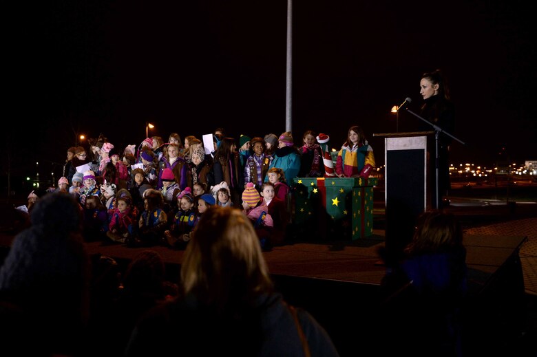 Children sing Christmas carols on stage during the annual tree-lighting ceremony at the Eifel Lanes Bowling Center on Spangdahlem Air Base, Germany, Dec. 4, 2014. The tree-lighting ceremony takes place annually and includes carols, hot chocolate, cookies, a speech from the wing commander and a visit from Santa Claus. (U.S. Air Force photo by Airman 1st Class Timothy Kim/Released)