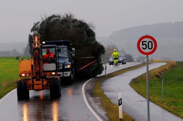 A truck assigned to the 52nd Civil Engineer Squadron drags an evergreen tree from Spangdahlem, Germany, Nov. 26, 2014. The city’s community donated the tree to Spangdahlem Air Base to support the tree-lighting ceremony. (U.S. Air Force photo by courtesy photo/Released)