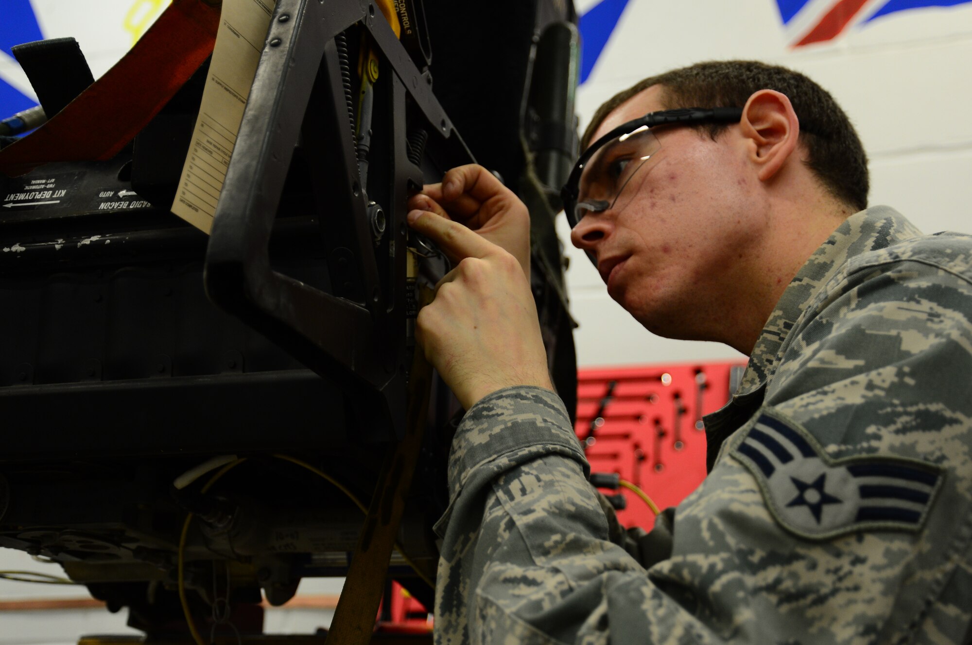 Senior Airman Eric Moseley, 48th Component Maintenance Squadron aircrew egress systems journeyman, works on an ejection seat rebuild for an inspection at Royal Air Force Lakenheath, England, Dec. 3, 2014. Moseley was nominated for a Liberty Spotlight because he embodies the core values of Service Before Self and Excellence in All We Do. (U.S. Air Force photo by Airman 1st Class Erin R. Babis/Released)