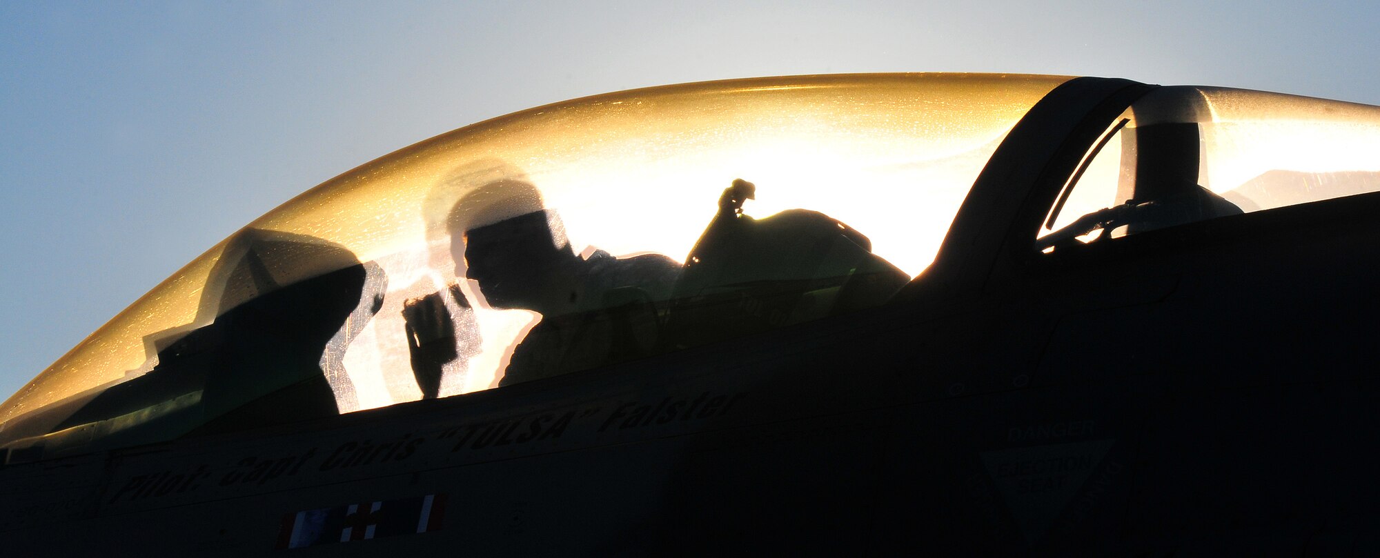 TOLEDO, Ohio - An Air National Guard technician from the 180th Fighter Group, Toledo, Ohio, cleans morning dew off the canopy of an F-16 Falcon as the sun is rising in preparation for a mission Sept. 7, 2014. (U.S. Air Force photo/Tech. Sgt. Frank Oliver)