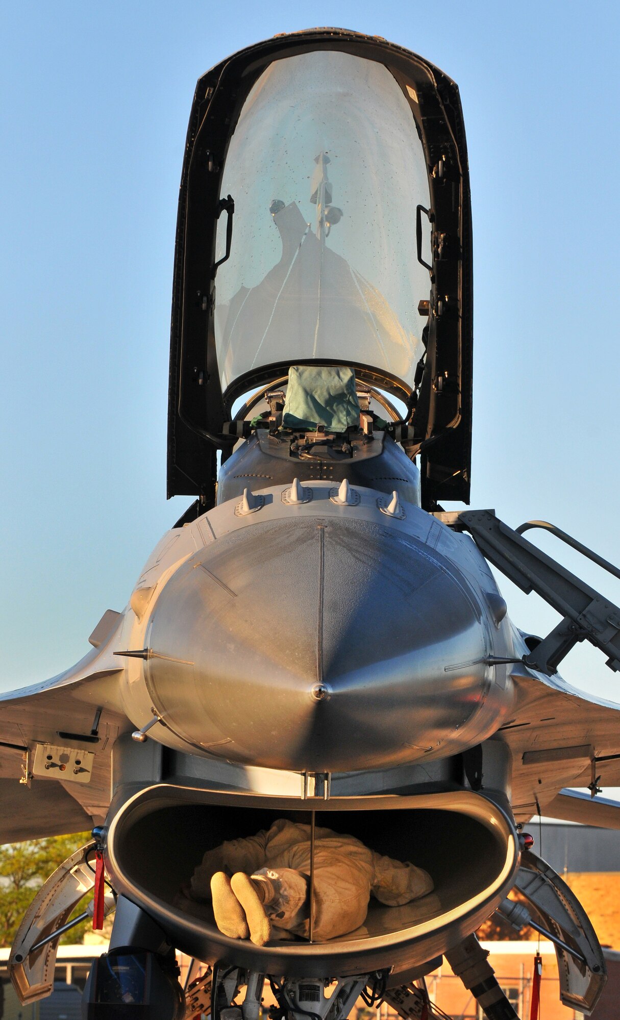 TOLEDO, Ohio - An Air National Guard technician from the 180th Fighter Group, Toledo, Ohio, checks for any foreign objects in the intake of an F-16 Falcon prior to take-off Sept. 7, 2014. The smallest amount of debris can cause thousands of dollars in damage to the aircraft if sucked up through the engine. (U.S. Air Force photo/Tech. Sgt. Frank Oliver)