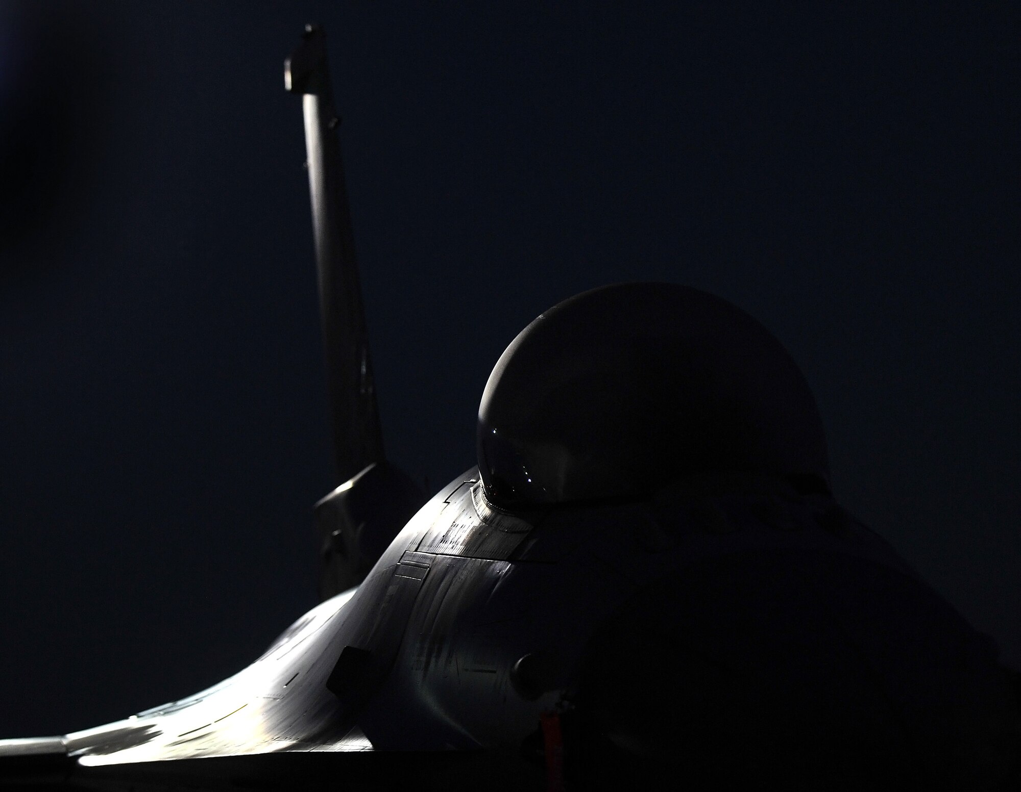 TOLEDO, Ohio - An F-16 Falcon fighter aircraft sits under the moonlight on the flightline at the 180th Fighter Wing, Ohio Air National Guard, Toledo, Ohio, Sept. 7, 2014. The mission of the 180th Fighter Wing is to train, organize, and equip expeditionary war fighters to deploy, fight, and win worldwide, with minimum response time, in cases of national emergency or war. (U.S. Air Force photo/Tech. Sgt. Frank Oliver)