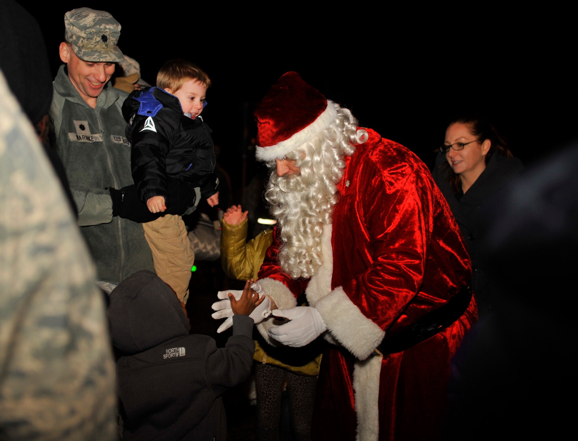 Santa Claus greets children during the tree lighting ceremony, Dec. 1, 2014 at Ramstein Air Base, Germany. The event consisted of musical performances, the tree lighting ceremony, a meet-and-greet with Santa and cookies and hot cocoa. (U.S. Air Force photo/Airman 1st Class Larissa Greatwood)