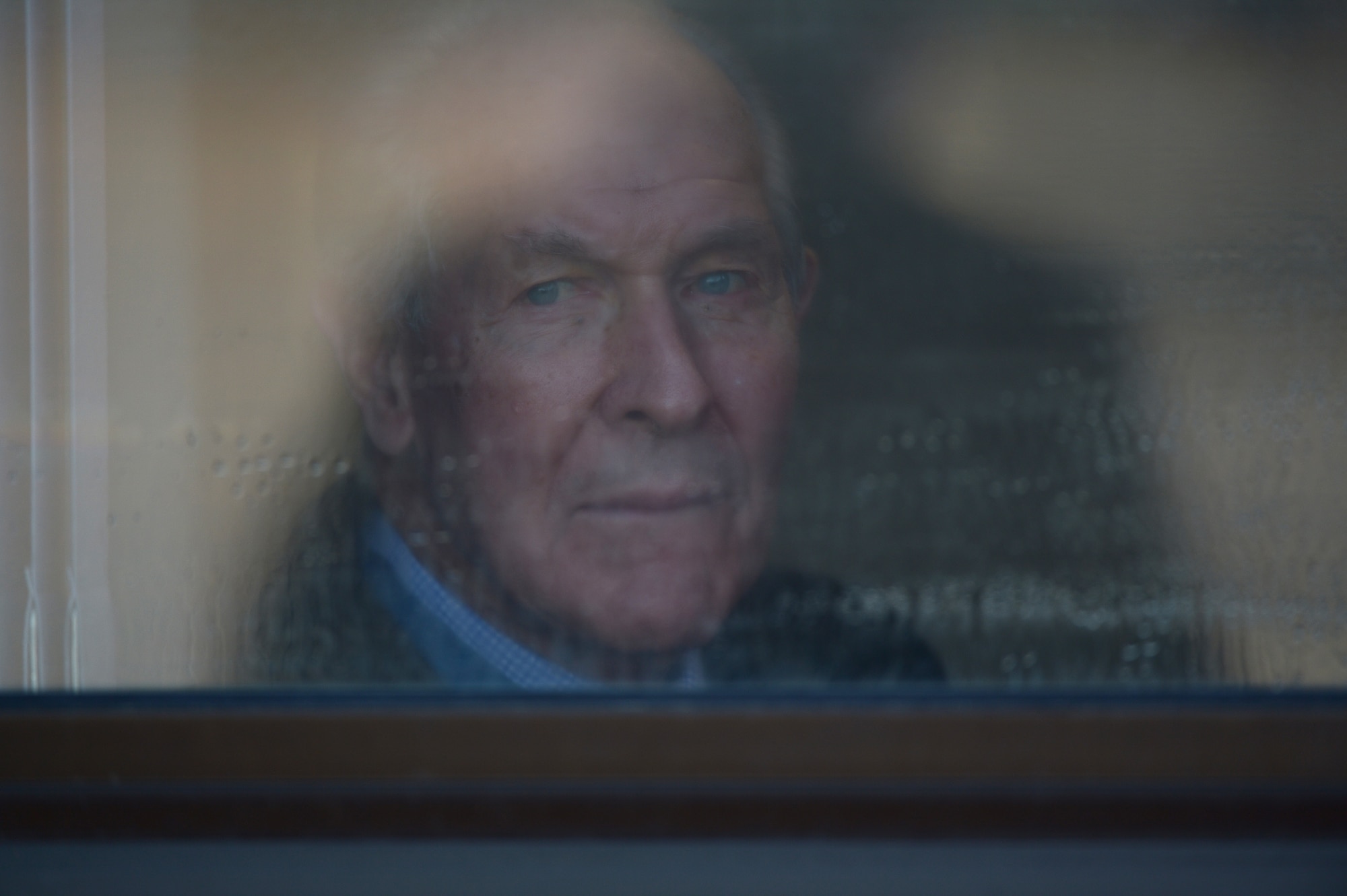 Medal of Honor recipient retired U.S. Navy Capt. Thomas Hudner Jr. watches through a window as the U.S. Navy F-18F Super Hornet from Strike Fighter Squadron 32, which bears his name on one side and Ensign Jesse Brown, the pilot Hudner tried to rescue, on the other, prepares to depart Hanscom Air Force Base Dec. 4, 2014. SFS 32 is the descendant of the unit Hudner flew with during the Korean War. Hanscom hosted the event on the 64th anniversary of the Korean War actions that earned Hudner his Medal of Honor. (U.S. Air Force photo by Jerry Saslav)