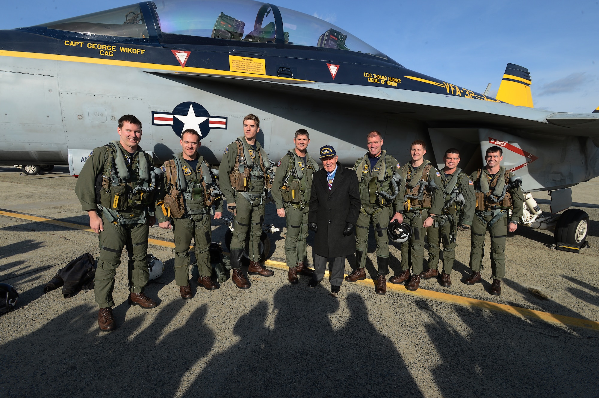 Medal of Honor recipient retired U.S. Navy Capt. Thomas Hudner Jr. poses for a photo with eight U.S. Navy aviators from Strike Fighter Squadron 32, during a ceremony in his honor at Hanscom Air Force Base, Mass., Dec. 4, 2014. SFS 32 is the descendant of the unit Hudner flew with during the Korean War. Hanscom hosted the event on the 64th anniversary of the Korean War actions that earned Hudner his Medal of Honor. (U.S. Air Force photo/Jerry Saslav) 