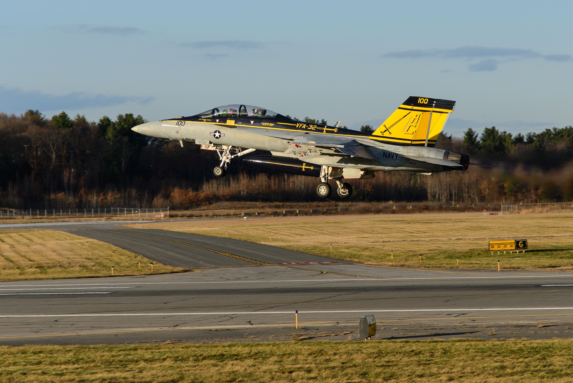 A Navy F-18F Super Hornet from Strike Fighter Squadron 32 out of Naval Air Station Oceana, Va., which bears the name of Medal of Honor recipient retired U.S. Navy Capt. Thomas Hudner on one side and Ensign Jesse Brown, the pilot Hudner tried to rescue, on the other departs Hanscom Air Force Base, Mass., Dec. 4, 2014. SFS 32 is the descendant of the unit Hudner flew with during the Korean War. Hanscom hosted the event on the 64th anniversary of the Korean War actions that earned Hudner his Medal of Honor. (U.S. Air Force photo/Mark Herlihy) 