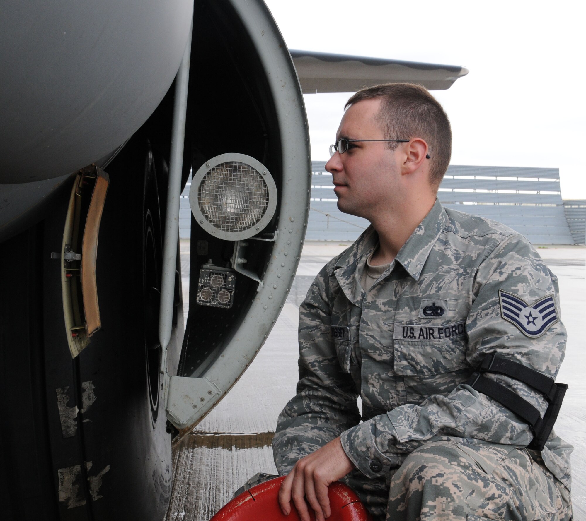 U.S. Air Force Staff Sgt. Andrew Morrissey, 352nd Special Operations Maintenance Squadron flying crew chief from Coral Springs, Fla., checks an MC-130J Commando II Oct. 21, 2014, on RAF Mildenhall, England. Morrissey services an aircraft prior to take-off. (U.S. Air Force photo by Gina Randall/Released)