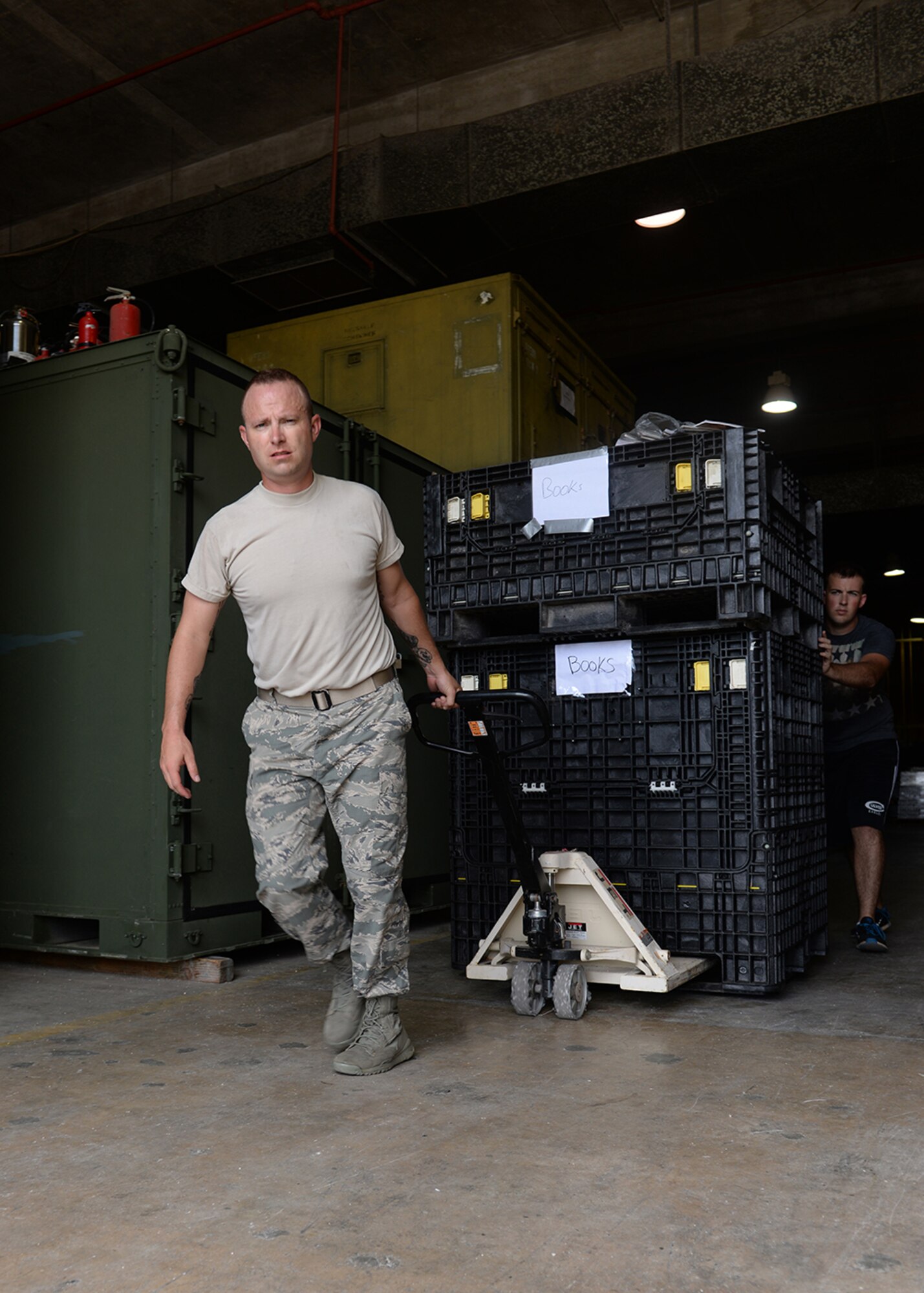 Master Sgt. Jesse Schwarztrauber, Operation Christmas Drop volunteer, moves crates containing donated items   Dec. 3, 2014, at Andersen Air Force Base, Guam. Operation Christmas Drop is an annual humanitarian airlift mission that began in 1952 and supplies more than 50 islands with boxes that contain donations such as non-perishable food items, clothing, medical supplies, tools, toys and other various items. (U.S. Air Force photo by Senior Airman Katrina M. Brisbin/Released.) 